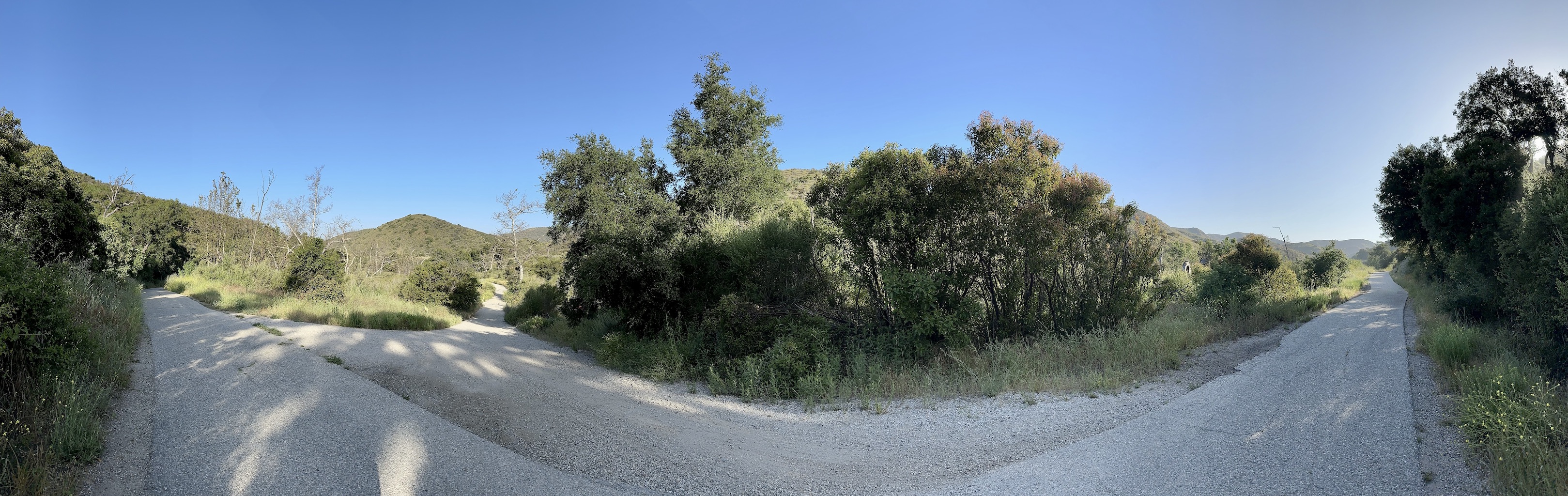 panorama of a rough-ish paved path in the middle of nowhere