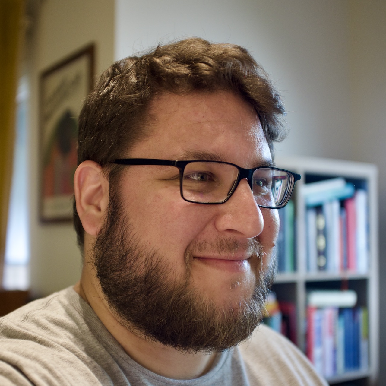 author’s self-portrait with a bookshelf in the background