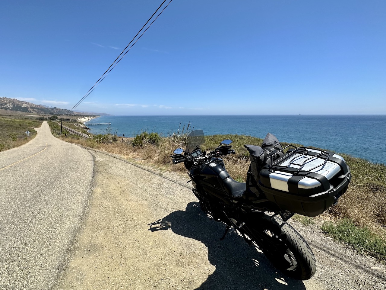 Yamaha FJ-09 parked on a road overlooking the Gaviota State Beach Pier and the Pacific Ocean