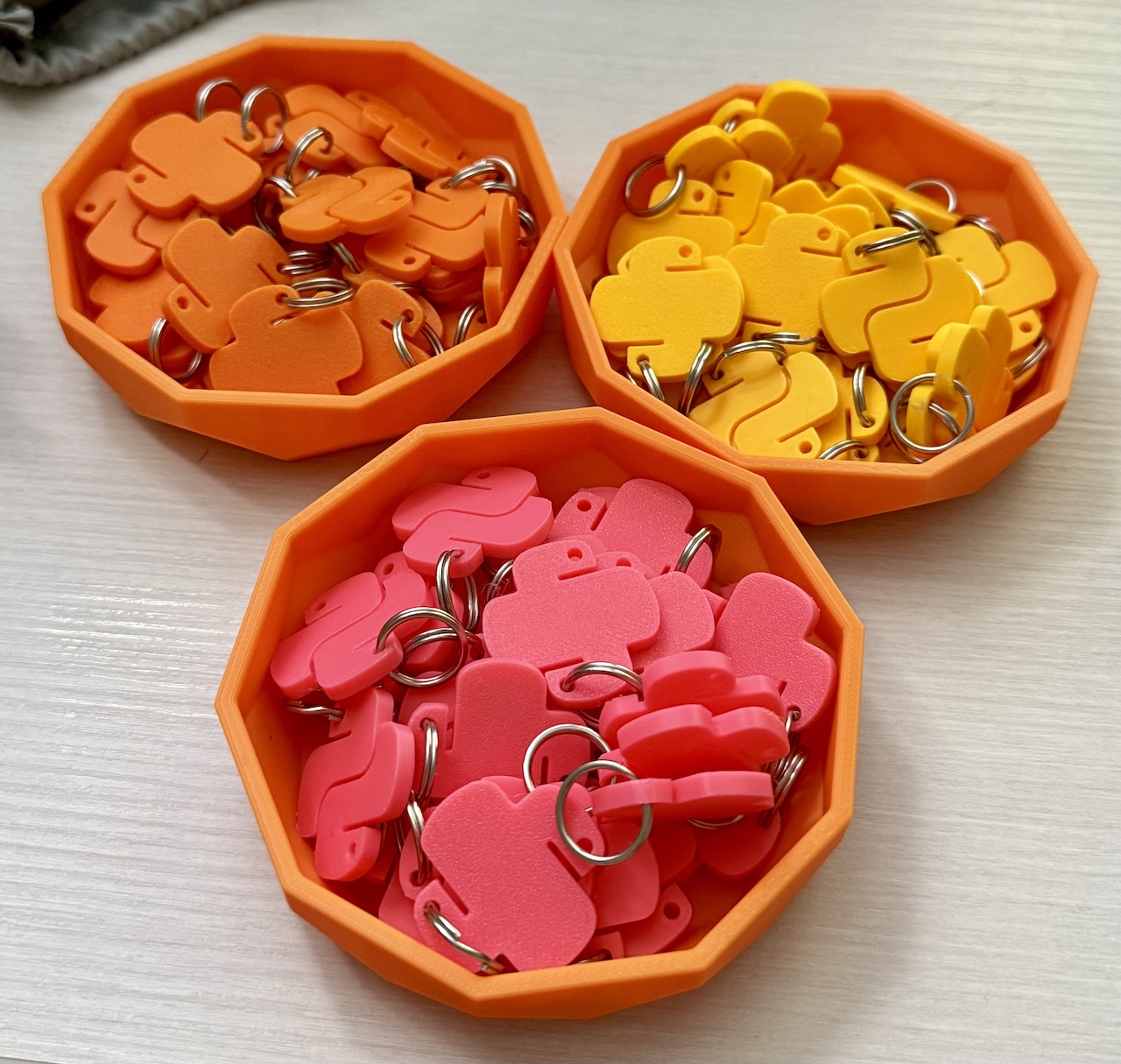 orange, yellow, and pink Python logo charms orange, yellow, and pink Python logo charms